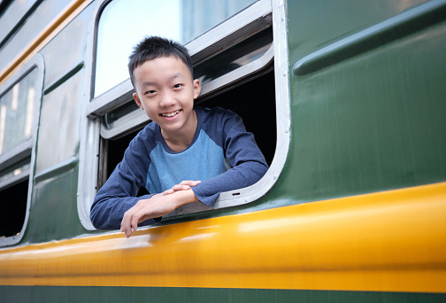 Portrait of boy sitting in the old train