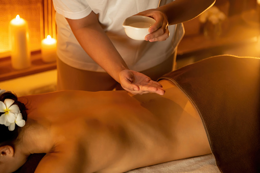 Masseuse prepare oil massage procedure for customer at spa. Quiescent