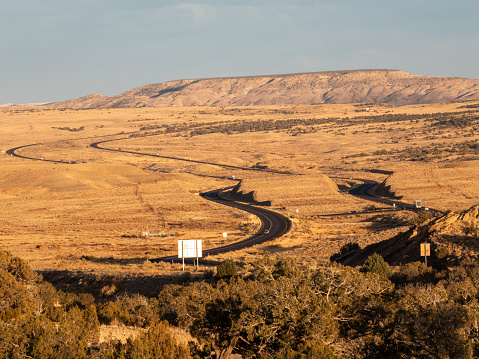 Distant view of traffic on a winding portion of Interstate 70 in the remote Utah desert.