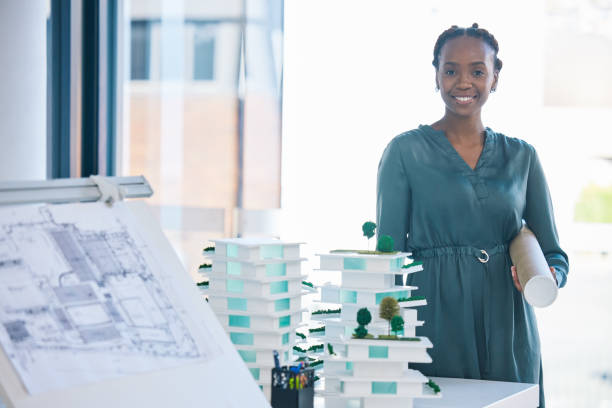 istock Female architect with architecture design, 3D model structure and creative blueprint sketch tools for a new designing project. Professional construction planner or artist with business framework plan 1796900869