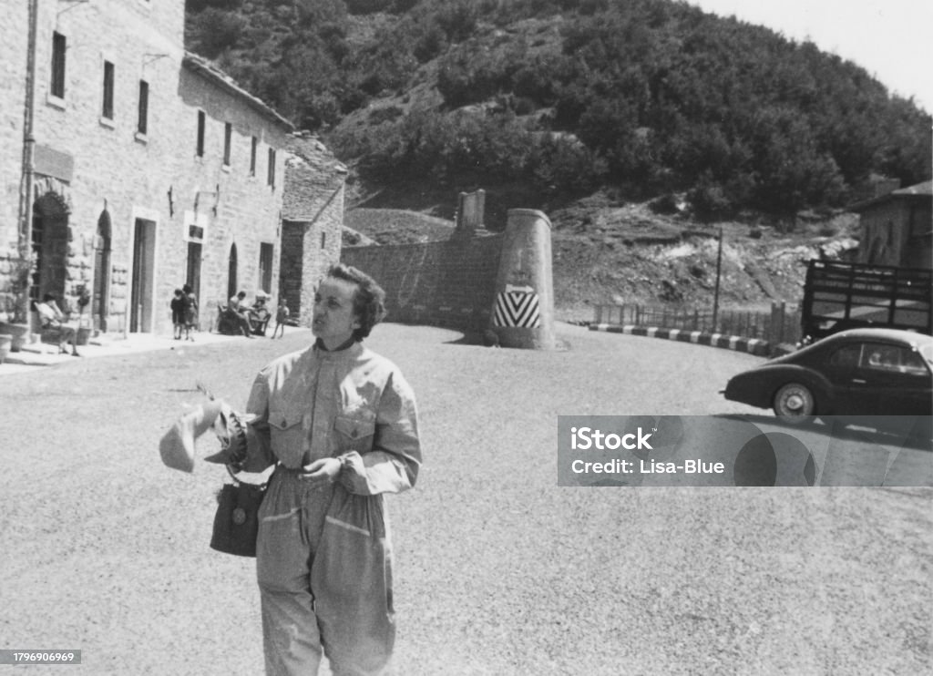 Woman in 1955. Woman walking on a road in 1955. 1940-1949 Stock Photo