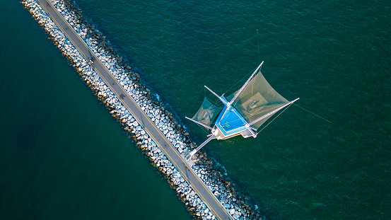 Traditional fishing industry, fisher house and nets on the coast of Marina di Ravenna, Italy - mediterranean sea. Aerial view