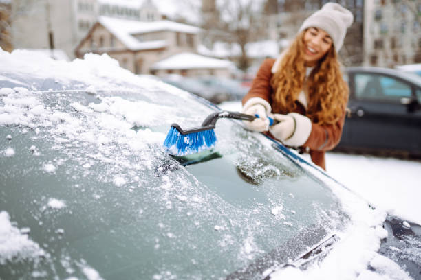 Cleaning snow from a car.