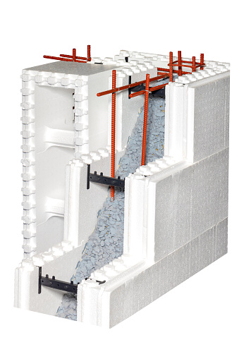 An example of the construction of a thermal house whose walls are made of polystyrene foam blocks filled with heavy concrete and which are permanent formwork. Isolated on a white background.