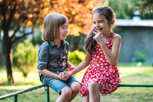 Two children having fun in the park.
