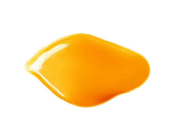 istock Flowing melted caramel syrup isolated on white background. 1796937026