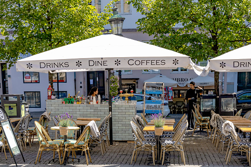 Cozy street cafe with empty tables on a summer day. Copenhagen, Denmark - September 15, 2023