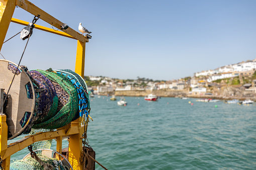 Fishing trawler net in Cornwall, with Mevagissey in background