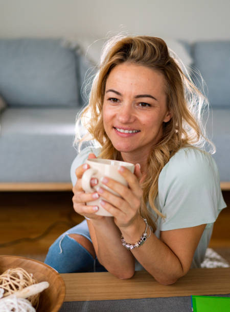 istock Happy woman drinking coffee at home 1796965126