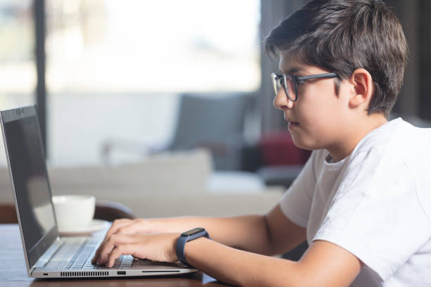 istock Teenager boy using laptop for homework 1796988173