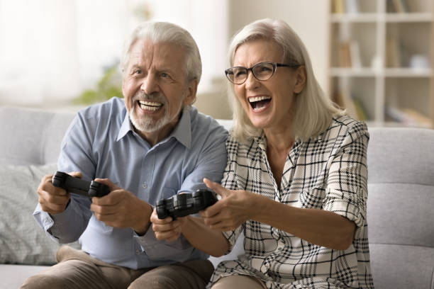 istock Cheerful excited senior couple playing online video game 1796991468