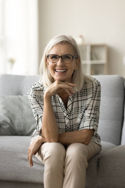 istock Cheerful beautiful senior lady leaning chin on hand 1796991508