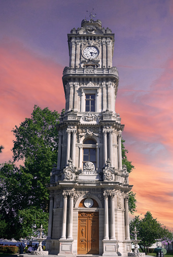 The clock tower was added to Dolmabahçe Palace, and stands in front of its Treasury Gate on a square along the European waterfront of Bosphorus next to Dolmabahçe Mosque.