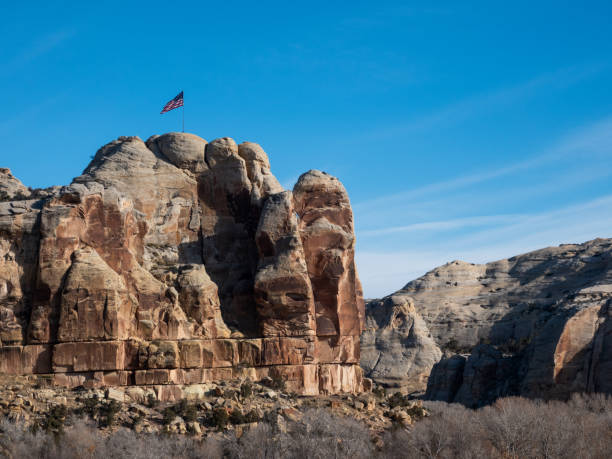 Large American flag on a high cliff near Vernal, Utah. Large American flag on a high cliff near Vernal, Utah. vernal utah stock pictures, royalty-free photos & images