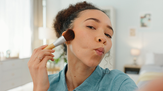 Makeup, video and face of woman in her home for social media, content creation or online blog review of product, cosmetics and beauty. Gen z influencer, filming cosmetic brush or live streaming tips