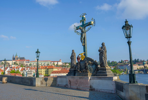 Statuary of the Holy Crucifix and Calvary on Charles Bridge, in Prague, Czech Republic, in sunny day