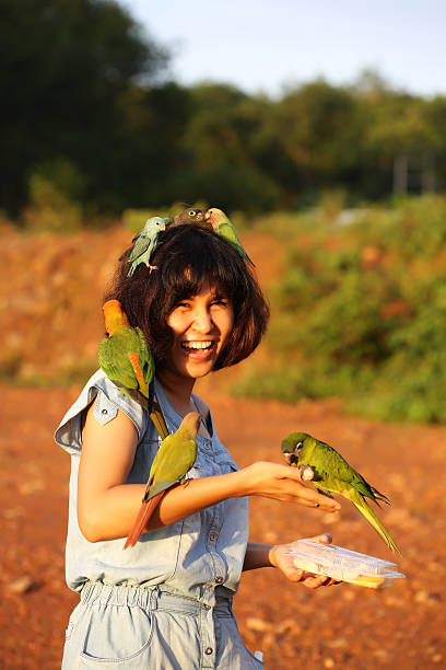 istock woman and many parrot 179700382
