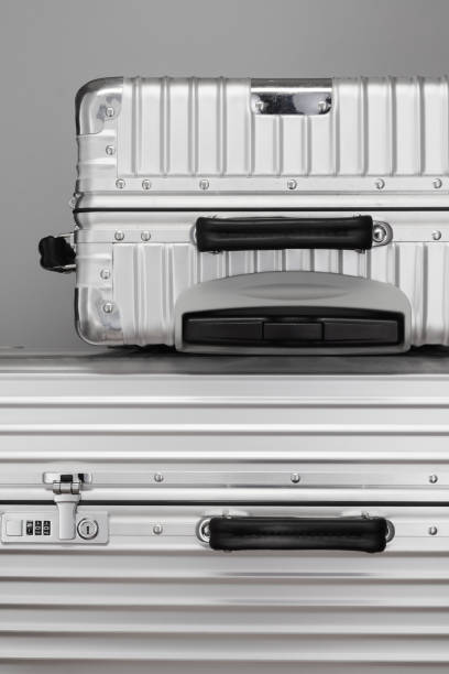 istock Two aluminum flight suitcases on gray background. 1797009351