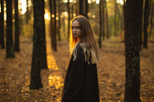 Blonde woman in the forest.