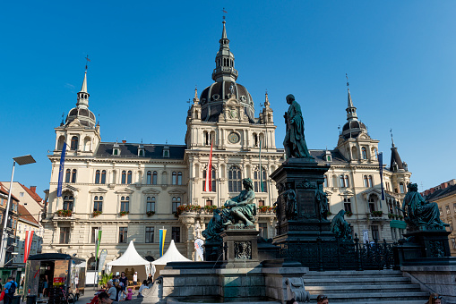 Graz, Austria - August 26, 2023: View of the central city square Hauptplatz with the fountain of Archduke John of Habsburg and the Rathaus palace home to the city hall