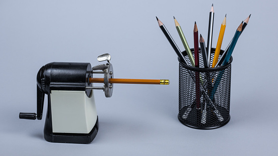 retro pencil sharpener with leaning pencil