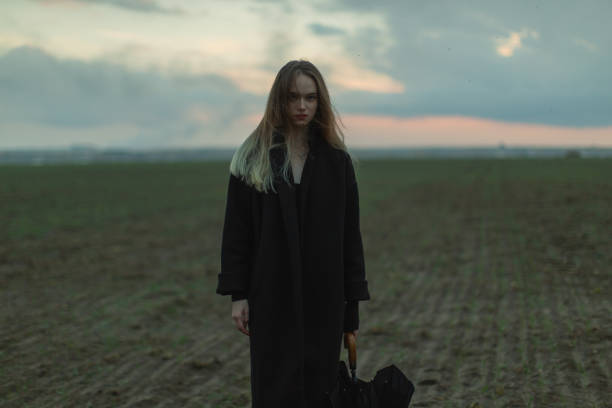 istock Blonde woman on the field. Sky background. 1797016620