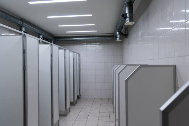 istock Public men's toilet finished with white ceramic tiles. 1797017141