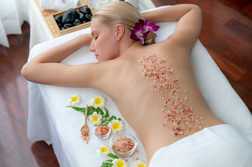 Woman customer having exfoliation treatment in luxury spa. Quiescent