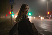 Woman on night city street background.