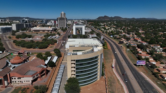 A bustling metropolitan area with a skyline of towering skyscrapers extending into the horizon, Gaborone, Botswana, Africa