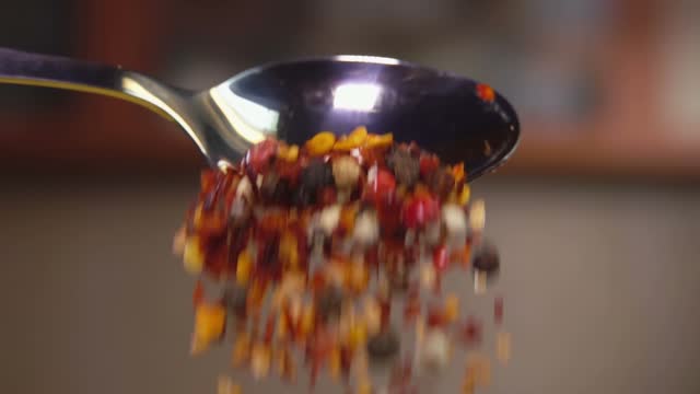 Spice mixture pours out of a spoon