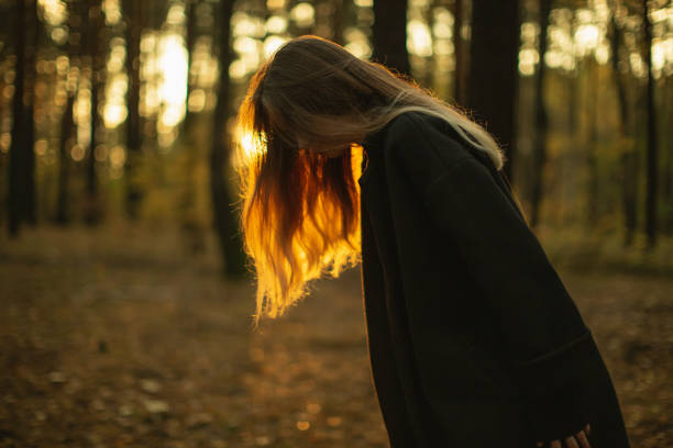 Blonde woman in the forest.