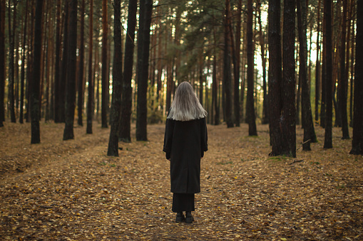 Blonde woman in the forest.