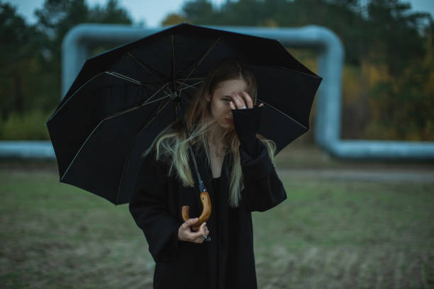 istock Woman with umbrella on the field. 1797061496