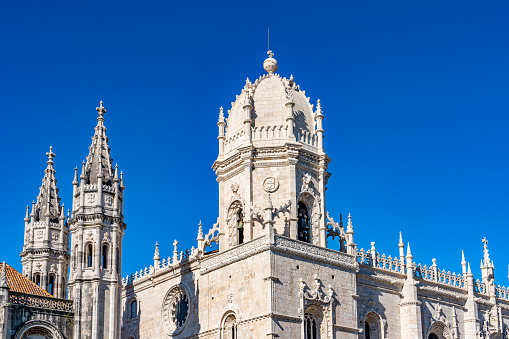 Balconies of colonial buildings with Iglesia La Compania de Jesus (Company of Jesus Church) in background.