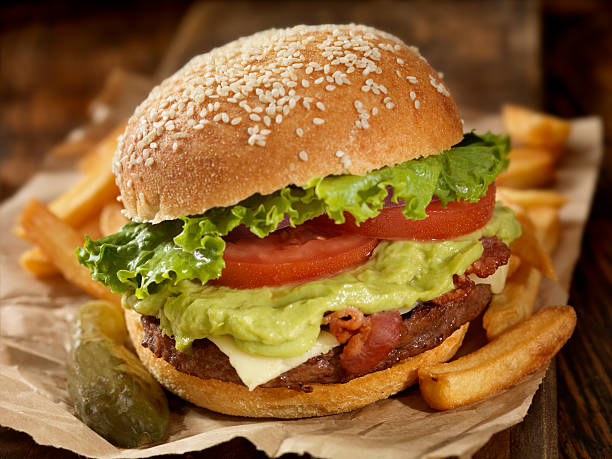 Closeup of a cheese burger with bacon and avocado