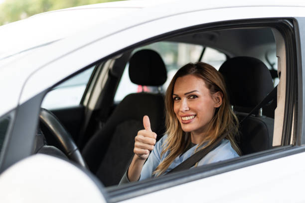 istock Nurse gesturing agreement with hand inside a car 1797088007