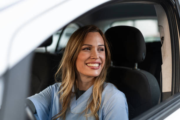 istock Smiling nurse going home by car after work 1797089084