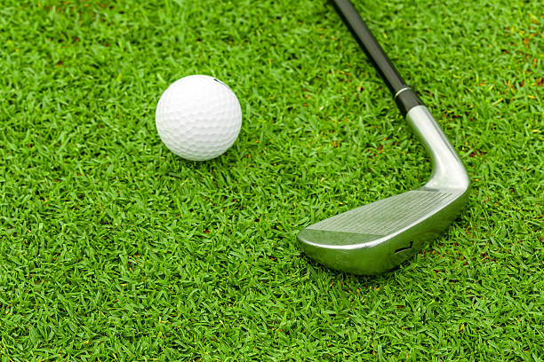 istock golf ball  tee in front of driver on green course 179709568