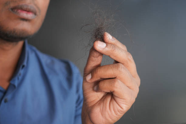 istock man hold his list hair close up 1797101522