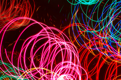 Abstract light painting of multiple warm, glowing neon colors, with a circular movement pattern.