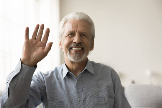 istock Cheerful elderly retired 70s man waving hand hello at camera 1797109977