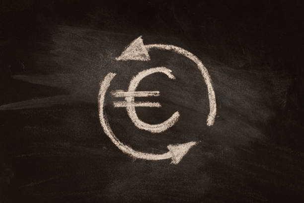 Icon, currency exchange symbol, euro with arrows, chalk drawing on blackboard. Иконка , символ обмена валют , евро со стрелками, рисунок мелом на доске. Крупным планом. irish punt note stock pictures, royalty-free photos & images