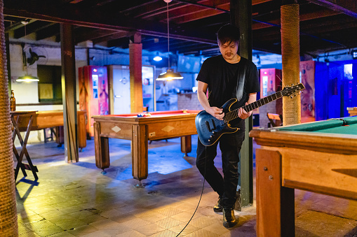 Rock guitarist playing guitar in a live show, lights and smoke