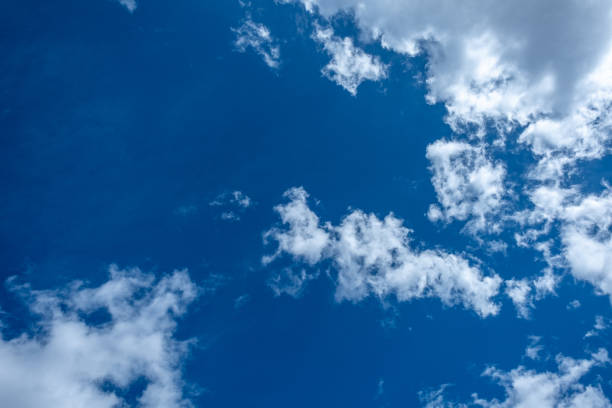 istock A vibrant blue sky dotted with white clouds backlit by the warm summer sunshine 1797154440