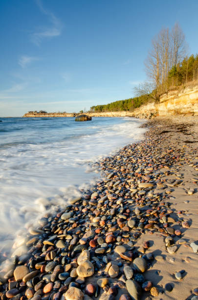 istock sunset beach, sandstone outcrop with motion wave 1797182818