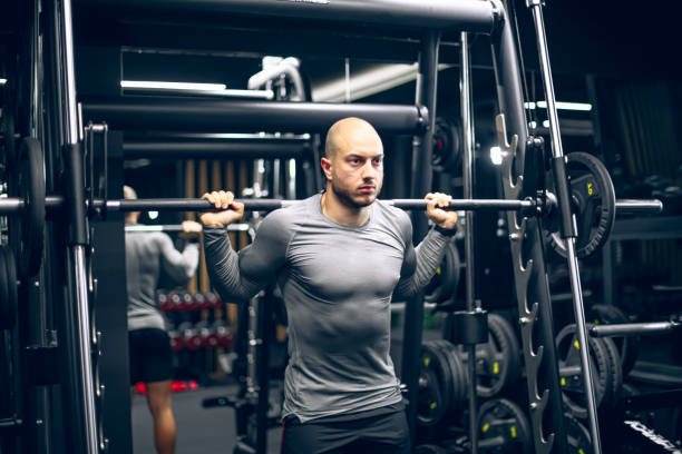 Asian man is lifting dumbbell for exercise. Concept, Exercise for health bodybuilding. Strengthen muscle. Weight lifting. Healthy lifestyle. Work out make strong of body.