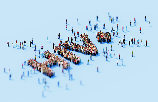 Human crowd forming HIV+ on blue background. Horizontal  composition with copy space.