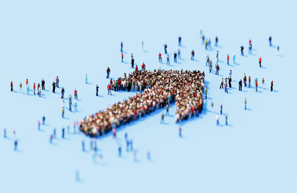 Human crowd forming arrow symbol on blue background. Horizontal  composition with copy space.