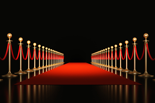 Red carpet on black background. Horizontal composition with copy space. Great use for red carpet related concepts.